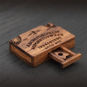 Miniature wooden spirit board box with sun and moon engravings and sliding lid