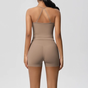 Detail of mocha racerback sports bra and high-waisted shorts with seamless texture