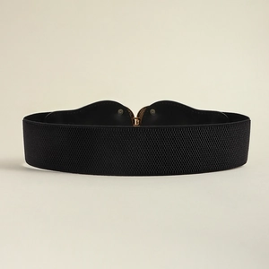 Detail of black elastic waist belt featuring a gold heart-shaped metal buckle design