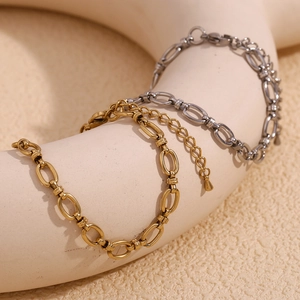 Close-up of gold and silver minimalist link chains with adjustable clasp on art stand
