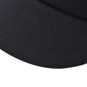 Macro view of black twill cotton fabric with detailed double stitching on the cap brim