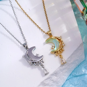 Artistic crescent moon necklaces with zircon accents and pearl inlay on a stone base