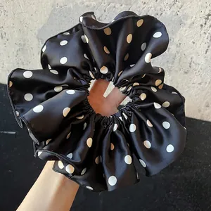 Classic black and white polka dot silk scrunchie with oversized ruffles for women