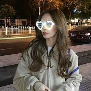 Luminous heart-shaped shutter shades with white LED lights worn by a model at night