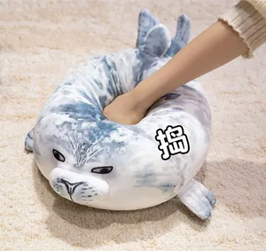 Close-up of soft grey spotted seal plush being pressed to show high elasticity and material