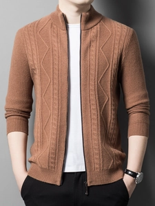 Detail of men's knitted cardigan showing standing collar and textured knit patterns