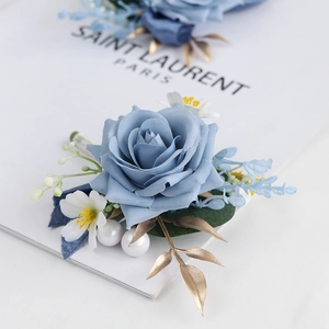 Elegant dusty blue silk rose boutonniere with pearls and gold leaf for wedding ceremony