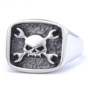 Men's punk stainless steel ring with skull and crossed wrenches on a textured seal face