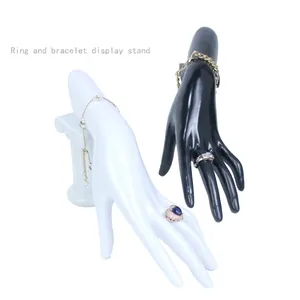 Glossy hand-shaped jewelry display stand for rings and bracelets on Roman column base