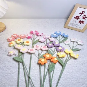 Handmade crochet puff flowers bouquet with colorful knitted blossoms and green stems