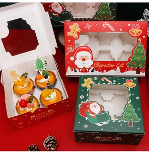 Detail view of red and green Christmas cupcake boxes with festive window designs