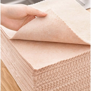 Textured absorbent dishcloth with scalloped edges shown on wooden surface