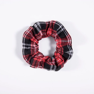 Close-up of red and black plaid cotton scrunchie texture and fabric pleats detail