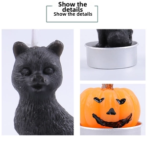 Detailed view of Halloween candles featuring black cat and orange pumpkin on metal bases
