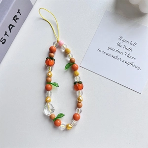 Close-up of pink tulip beaded phone charm strap with orange acrylic beads on white background