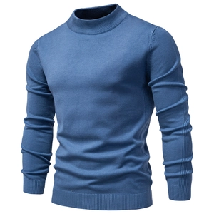 Detailed view of the thick blue knit texture on a men's slim fit turtleneck sweater