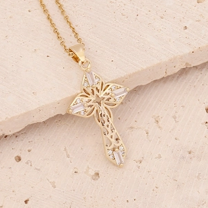 Detailed view of hollow 18K gold cross pendant with micro-pave cubic zirconia on stone
