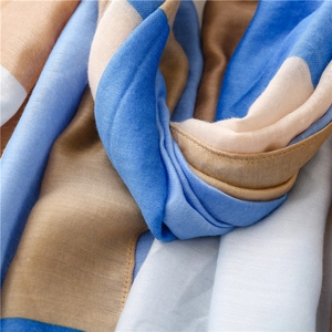 Close-up of knit fabric texture with blue, brown, and white geometric color blocks
