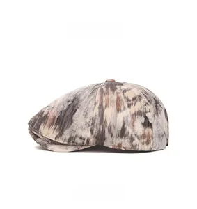 Side view of gray-brown newsboy cap in textured wool fabric with six-panel tailoring