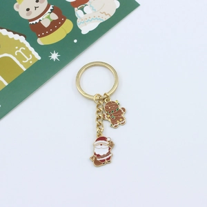 Detail of Christmas keychain with gingerbread man and Santa Claus enamel charms