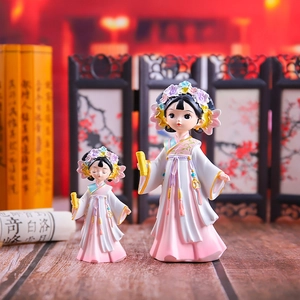 Close-up of resin Hanfu lady figurines in pink and white with antique study background