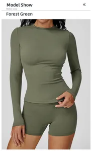 Front view of forest green slim-fit long-sleeved yoga top on model in studio