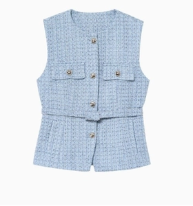 Detailed texture of light blue tweed vest with gold buttons and matching belt