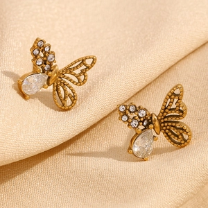 Macro shot of 18K gold plated asymmetric butterfly studs with cubic zirconia detail