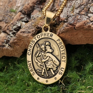 Macro shot of gold Saint Christopher oval pendant on a box chain with vintage finish