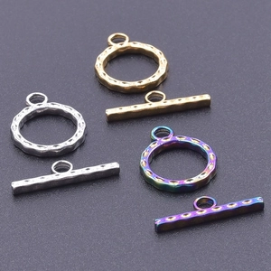 Detailed view of hammered metal toggle clasps in gold, silver and rainbow colors