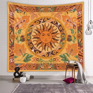 Detail of bohemian sun tapestry with zodiac symbols hanging on a white brick wall
