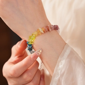 Macro view of colorful natural stone beaded bracelet worn on a woman's wrist
