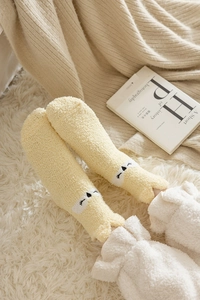 Detail of yellow coral fleece socks with cute cartoon animal face and soft V-shape opening