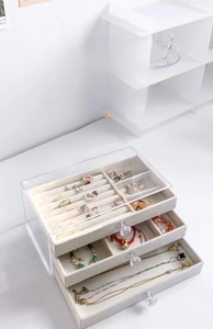Three-layer clear acrylic jewelry box with beige velvet lining and drawer compartments