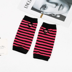 Detail of pink and black striped knit fingerless gloves with a cute cat ear cutout design