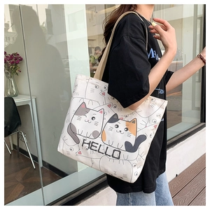 Close-up of a large canvas tote bag with a cute cartoon cat print and HELLO text
