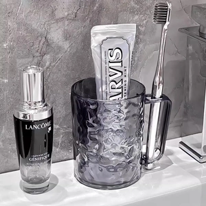 Glacier texture smoky grey transparent toothbrush cup in a modern bathroom setting