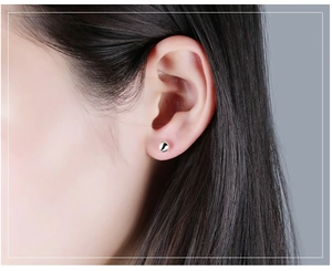 Minimalist S999 sterling silver ball stud earring shown on ear for a delicate look