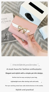 Close-up of pink lychee grain leather purse with golden bow buckle and V-shape detail