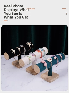Bamboo and velvet T-bar jewelry stands showing bracelets on a marble surface