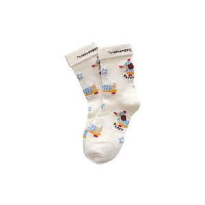 White cotton crew socks for kids featuring colorful cartoon puppy prints and folded cuffs