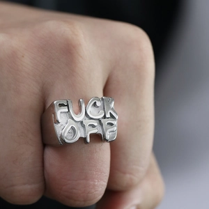 Detailed close-up of a silver stainless steel ring with bold FUCK OFF letter relief
