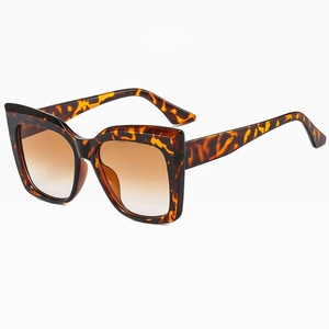 Detailed side view of oversized leopard print sunglasses with gradient brown lenses