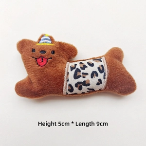 Close-up of plush bear brooch with party hat and leopard print, size 5cm x 9cm