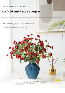 Artificial red rose bunch in blue ceramic vase for elegant home desktop decoration