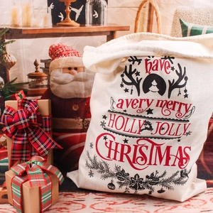 Large linen Christmas drawstring gift bag with festive Holly Jolly print and deer motifs