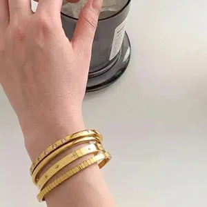Gold plated titanium steel zircon bangles set of 4 with star engraving and smooth finish