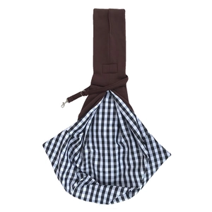 Detail of pet sling carrier featuring brown fabric, plaid lining, and safety hook