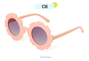 Side view of pink sunflower shaped sunglasses for kids with round gradient lenses