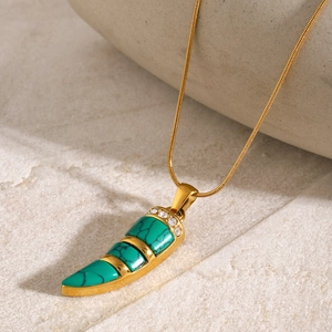Detail of 18k gold stainless steel necklace with horn pendant and cat eye stone